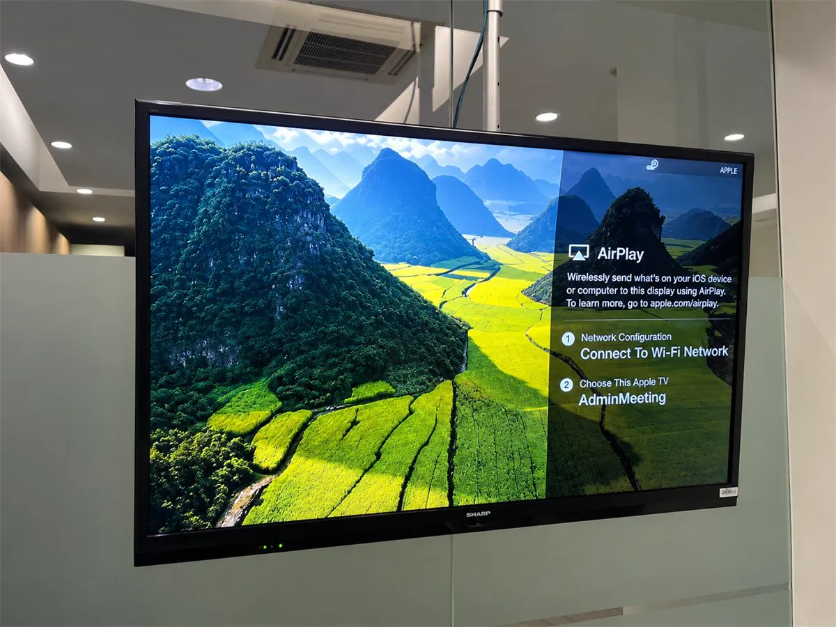 Wall-mounted display in the canteen showing the AirPlay sharing screen