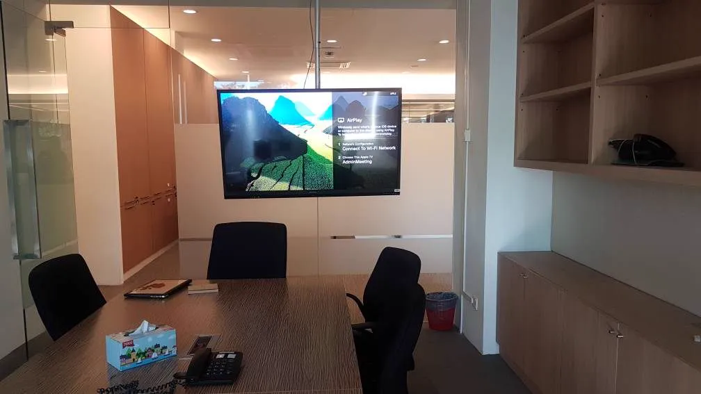 Meeting room with a wall display above the table